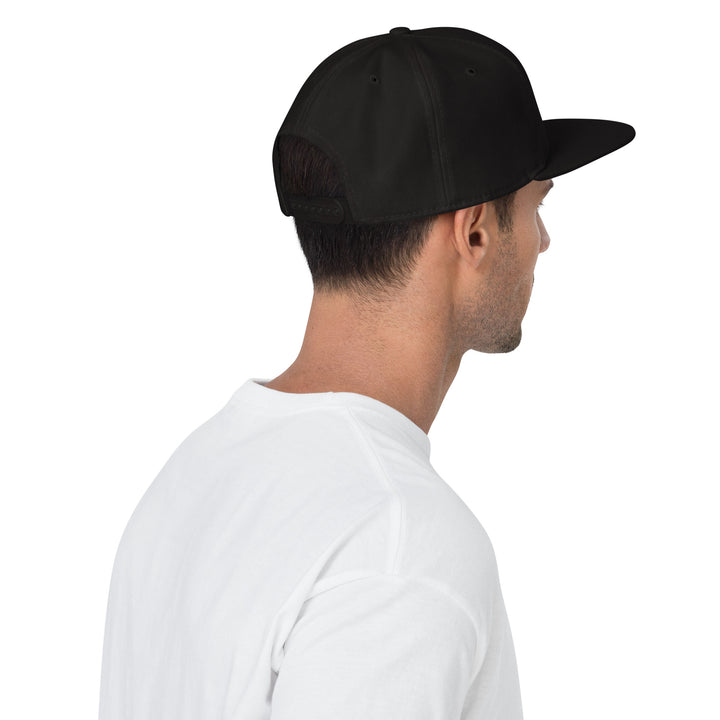 Ruffian Snapback Rear Black Hat With Grey Ruffian Puff Embroidered Logo On Model With White Shirt White Background