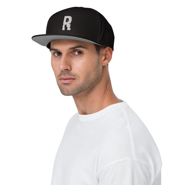 Ruffian Snapback Black Hat With Grey Ruffian Puff Embroidered Logo On Model With White Shirt White Background